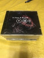 Stack of nine identical sealed CDs titled '21 Years & Beyond 1977 - 1998' by Beggars Banquet