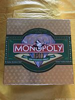 Top view of the Monopoly 60th Anniversary Edition limited edition box with diamond graphic and Mr. Monopoly logo.