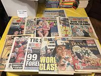 Collection of old Toronto newspapers laid out on a table showing multiple front pages and sports headlines from 1990s and 2000s.