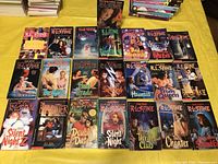 Photo showing 21 R.L. Stine novels arranged on a yellow background, various titles from Fear Street and other series.