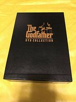Black box with gold text reading 'The Godfather DVD Collection'.