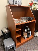 Desk with angled top and multiple compartments, some scratches visible, items on and in desk not included in sale