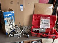 Full lot showing Test Rite drill press stand components and Milwaukee drill in case with manual
