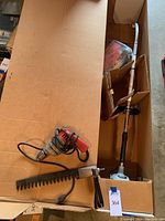 Photo showing Echo GT-201R grass trimmer in box alongside electric tools