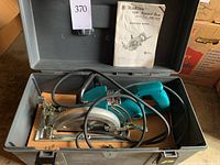 Top view of saw inside carrying case with instruction manual displayed