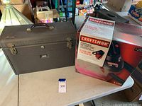 Lot showing Craftsman boxed portable wet/dry vacuum and gray Kennedy Kits metal toolbox together on table.