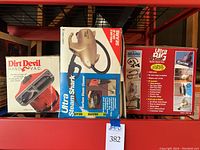 Three boxed vacuum/cleaning devices including Dirt Devil Hand Vac, Ultra Steam Shark hard surface steam cleaner, and Ultra Big Shark turbo hand vac.