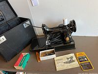 Singer Featherweight 221K with manual, oil, bobbins, case lid open