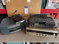 Four audio components arranged on a table: two curved grey Bose modules, Sony CD player, Bogen amplifier, Quadraflex receiver