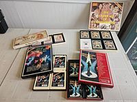 View of four boxed 8-track collections arranged on table showing front and top views of boxes and tape cartridges.