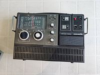 Front view showing control knobs, tuning dial display, speaker grill, and brand name on receiver.