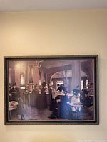 Framed painting showing detailed cafe interior scene with patrons in period dress