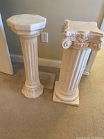 Front view of two ceramic pedestals showing their height and design