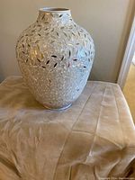Front side view of the Pier One vase showing the mosaic reflective surface and shape.