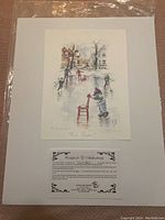 Photo of the artist print laid on plastic, showing a winter ice skating scene with children and houses, signed and numbered.