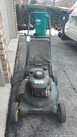 Front view of the used Craftsman lawn mower showing the full mower including wheels, handlebars, and attached grass catcher bag.