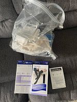 Clear plastic bag with multiple pairs of stockings inside and informational leaflets visible outside the bag