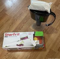 Photo showing the Brita water filter jug and the boxed Starfrit Pro Mandoline on the floor.
