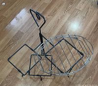 Pampered Chef serving rack with black metal frame and handle on wood floor