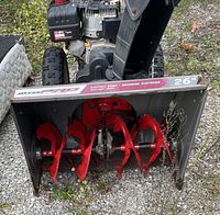 Close front view of the snowblower with visible red auger blades and Snow King and Mod Pro branding on the housing.