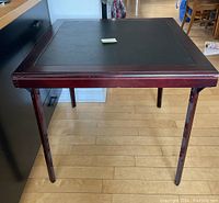 Front view of the 32 inch square card table with dark wood legs and vinyl top.