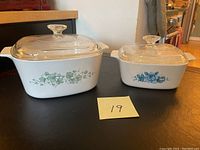 Two CorningWare casserole dishes with lids, showing both dishes side by side