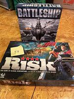 Photo showing Battleship and Risk board game boxes stacked, clearly displaying titles and artwork.
