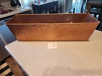 Top view of hammered copper rectangular plant holder showing its size and texture.