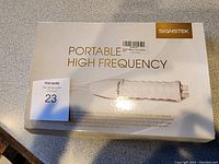 Top view of the box featuring the Signtek branding and product name 'Portable High Frequency' along with the handheld device image.