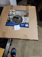 Closed cardboard box packaging of the G2 GroundBlind hunting blind showing product label and faint camo pattern.