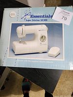 Box front showing image and model of the Jo-Ann Essentials Super Stitcher SE300 sewing machine