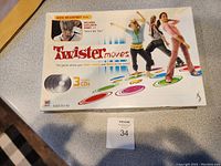 Front of Twister Moves game box showing title, people playing with colorful circles, and promotion of 3 included CDs with a Jesse McCartney remix.