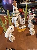 Close-up of Southwestern Native American themed nativity set with teepee and figures dressed in traditional garments, including animals and cacti