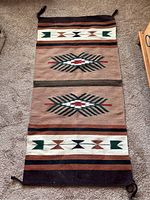 Full view of the Southwestern wool rug laid flat showing overall design and colors.