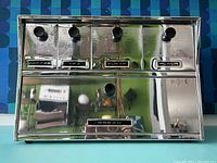 Front view showing labeled compartments for coffee, tea, sugar, flour, and large bread box below.