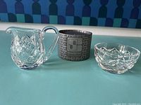 Three-piece lot consisting of Waterford small creamer pitcher, trinket bowl, and a decorative box likely for the Swarovski owl figurine.