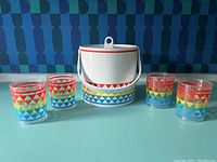 Image showing the vintage white ice bucket with colorful geometric triangle bands and the four matching plastic cups.