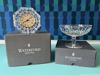 Both Waterford clock and compote displayed on their original black Waterford Crystal boxes, showing overall condition and size comparison.