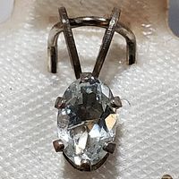 Front view of pendant showing oval aquamarine and prong setting