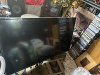 Samsung 53-inch TV placed in a home environment showing screen and black bezel, no stand attached.