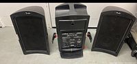 Photo showing the Fender PA system speakers and central control unit from the front and top angle.