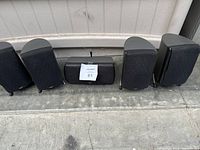 Group photo of five Klipsch speakers and one center channel speaker placed side by side.
