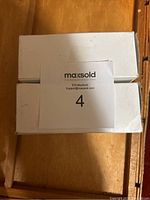 Photo of the lot showing two sealed white boxes containing pressure sensors with MaxSold sticker on top.