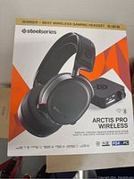 Front view of SteelSeries Arctis Pro Wireless headphones box showing the product image and key features.