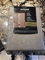 Front packaging showing Eclipse brand label and product details including energy-saving and noise reducing benefits, package contains 2 panels each 52 x 84 inches.