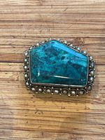 Front view of the vintage pentagon-shaped brooch showing the polished Eilat stone surrounded by pearls in silver setting.