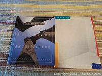 Cover of architectural history book with a close-up image of a classical column and blue sky background