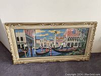 Full view of large needlepoint artwork in ornate vintage frame showing Venice gondolas and buildings
