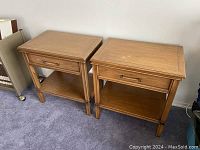 Pair of two night tables side by side on carpeted floor