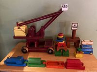 Full set of vintage Playskool wooden toys including crane, train, blocks, and signpost on table